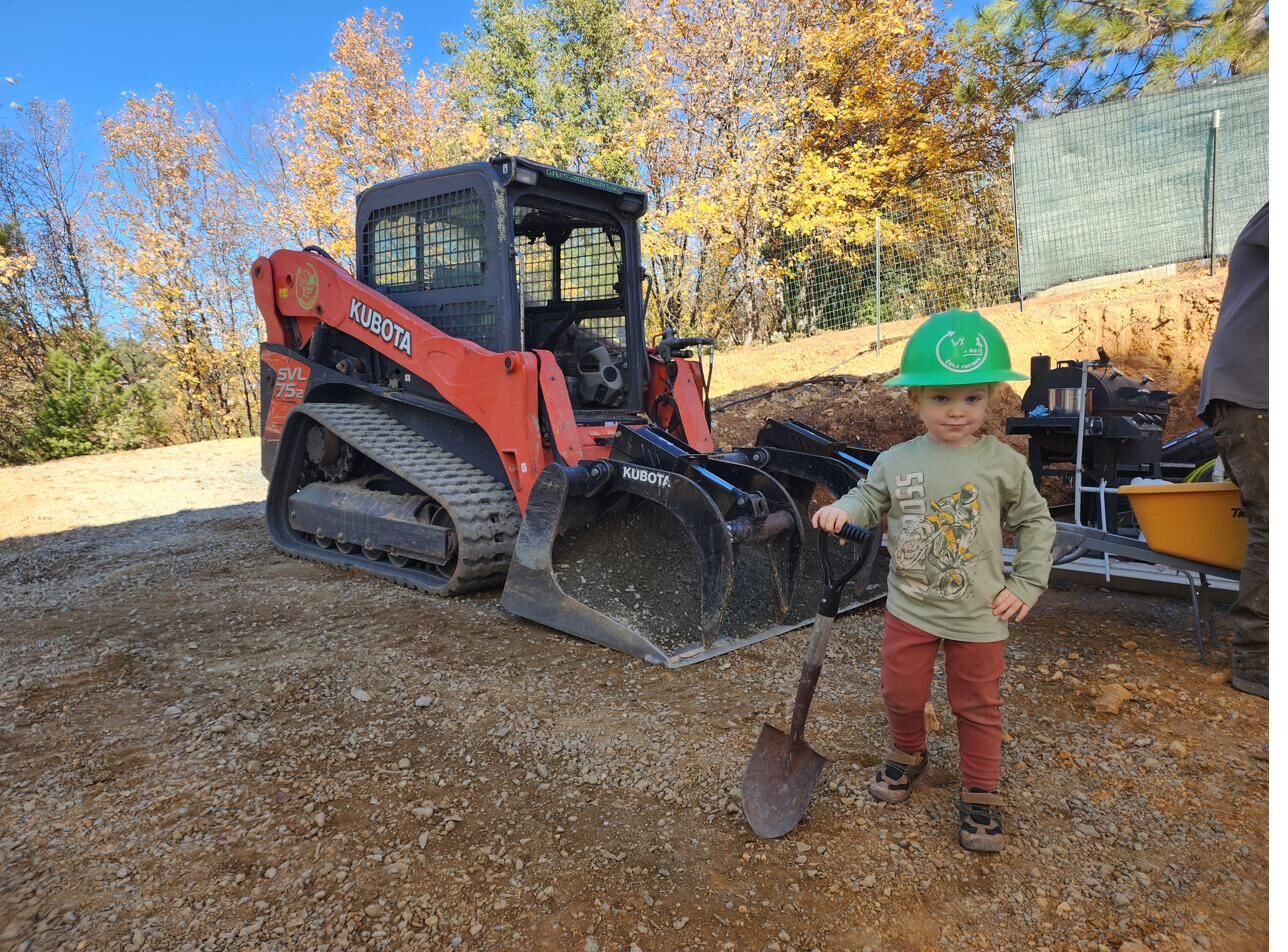 Felix Raniolo in a Green Constructors hard hat on a job site