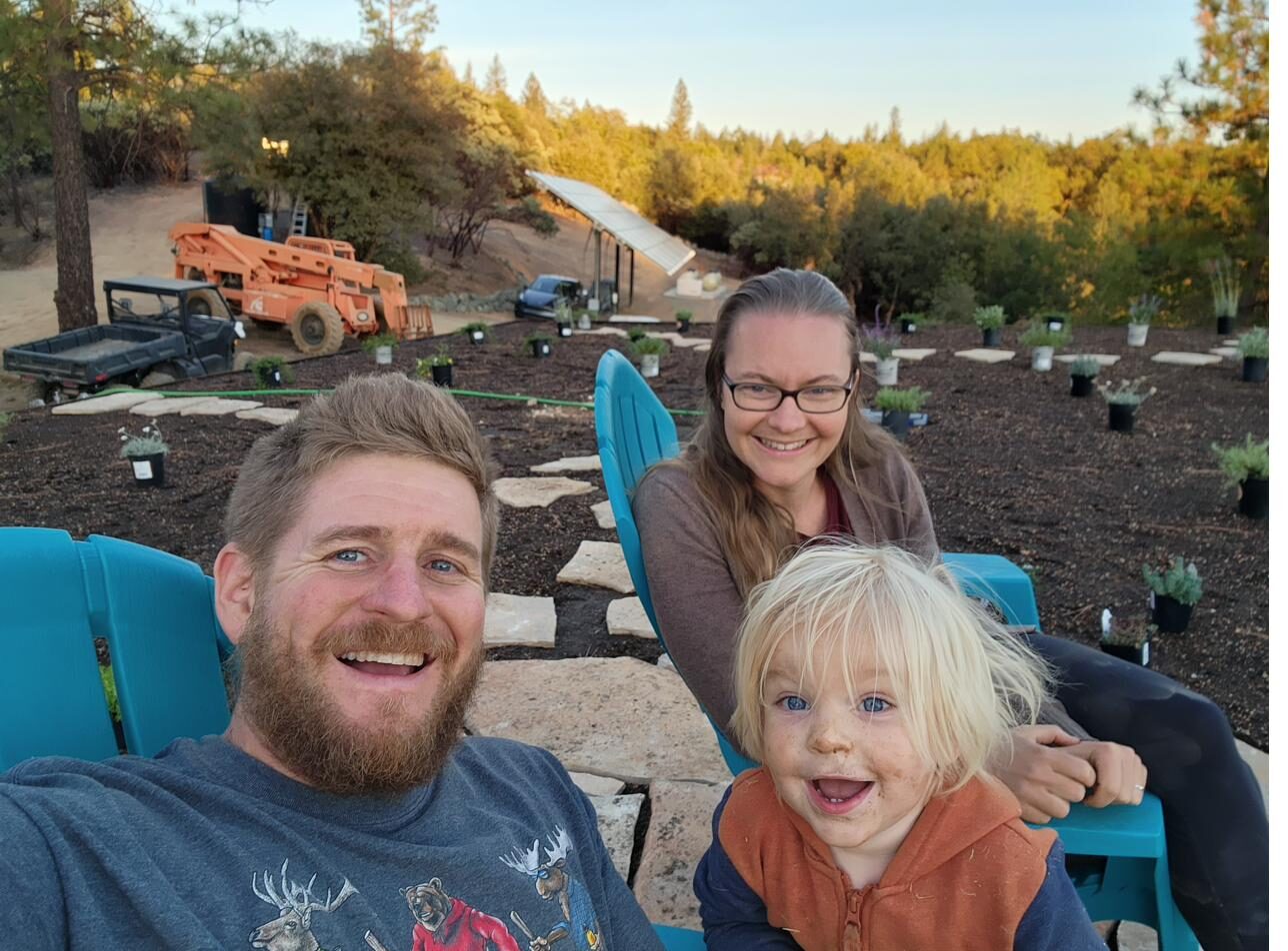 Family relaxing on the completed green roof at sunset among fresh plantings