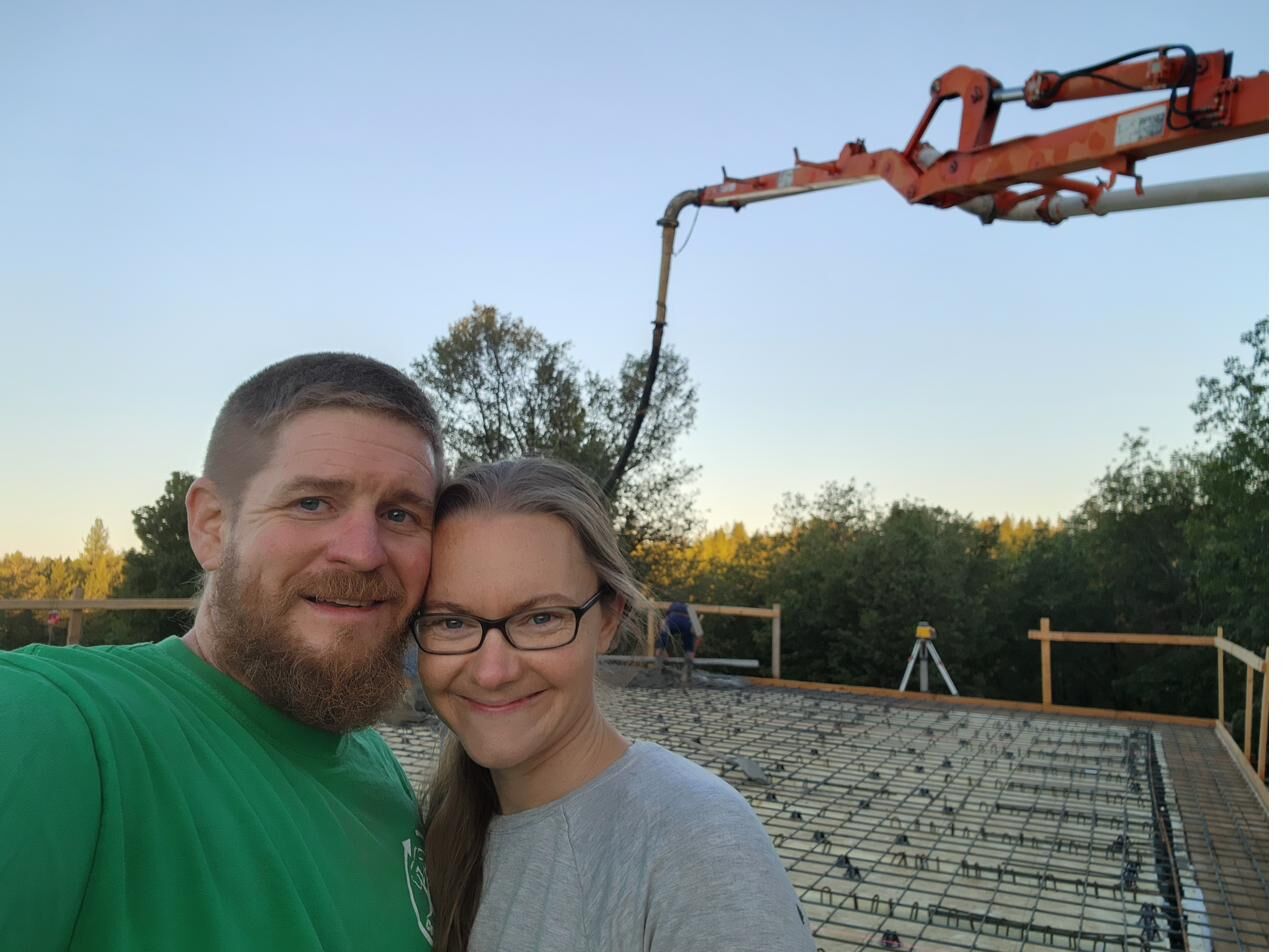 On the roof deck before the concrete roof pour, rebar mat and pump boom staged