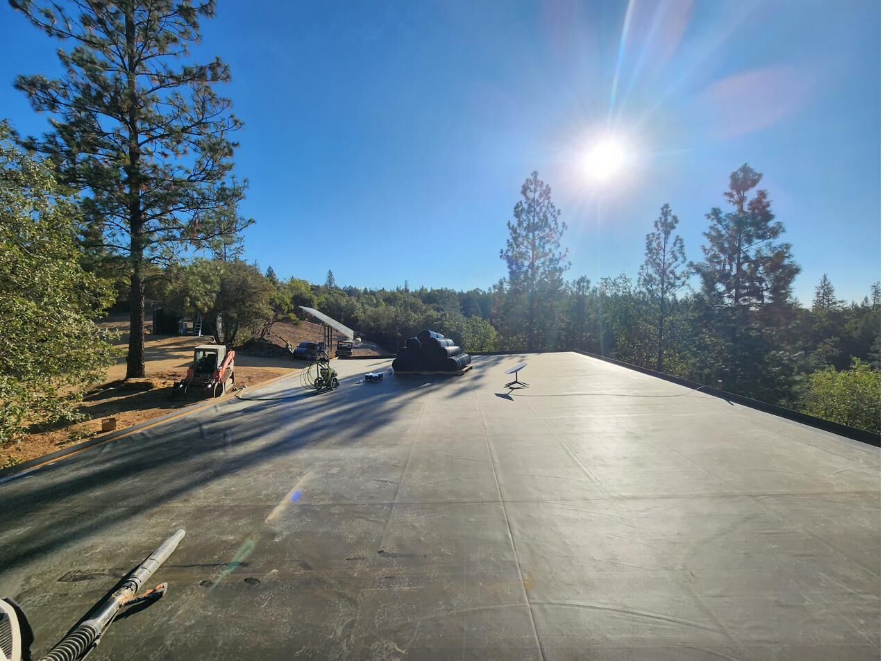 EPDM rubber waterproofing membrane rolled across the concrete roof with Starlink dish installed