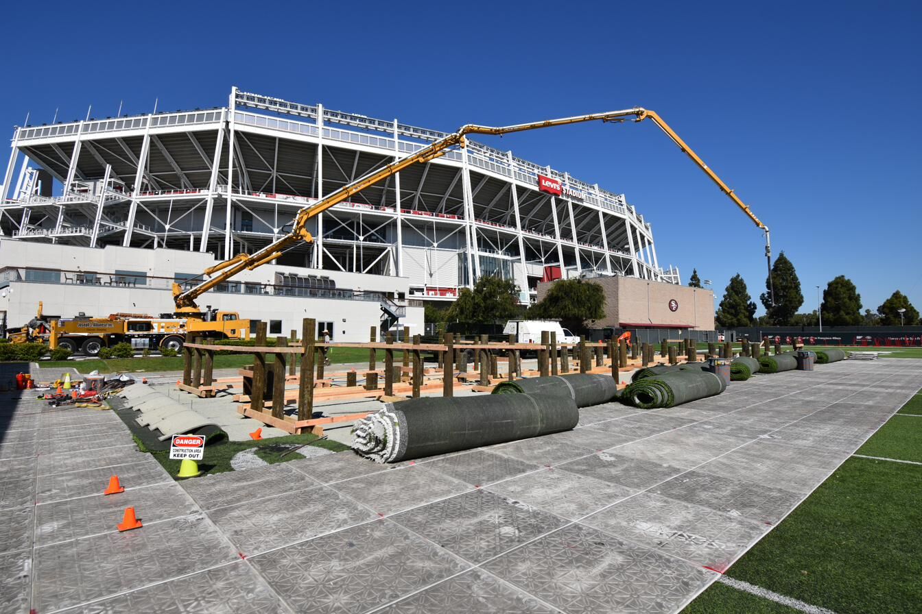 Concrete pump truck with extended boom placing footing concrete at Levi's Stadium