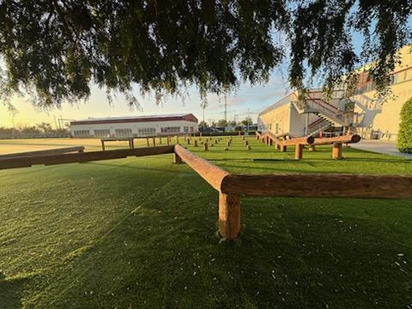 Golden-hour ground-level view of the completed relocated 49ers obstacle course