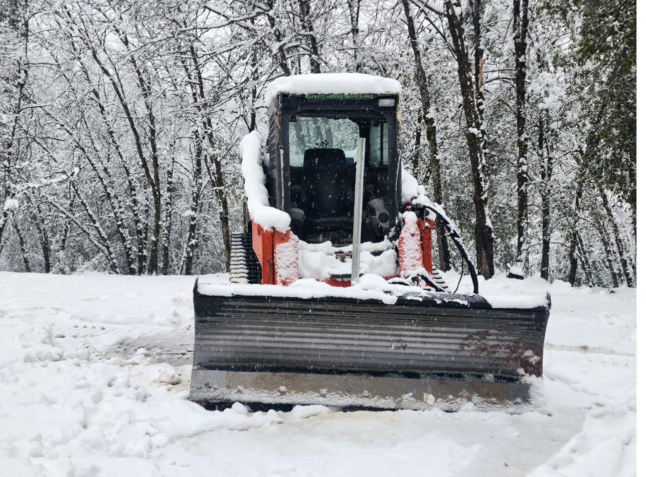 Kubota SVL 75-2 skid steer covered in snow during Sierra storm response